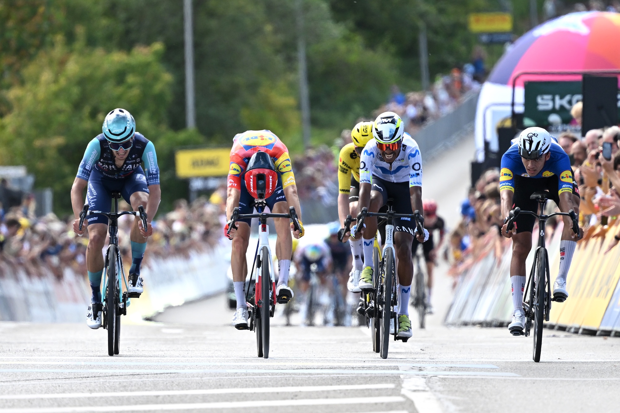 Isaac Del Toro of UAE Team Emirates - XRG (far right), in the Blue Leader Jersey, sprints to second place at finish line of stage 1