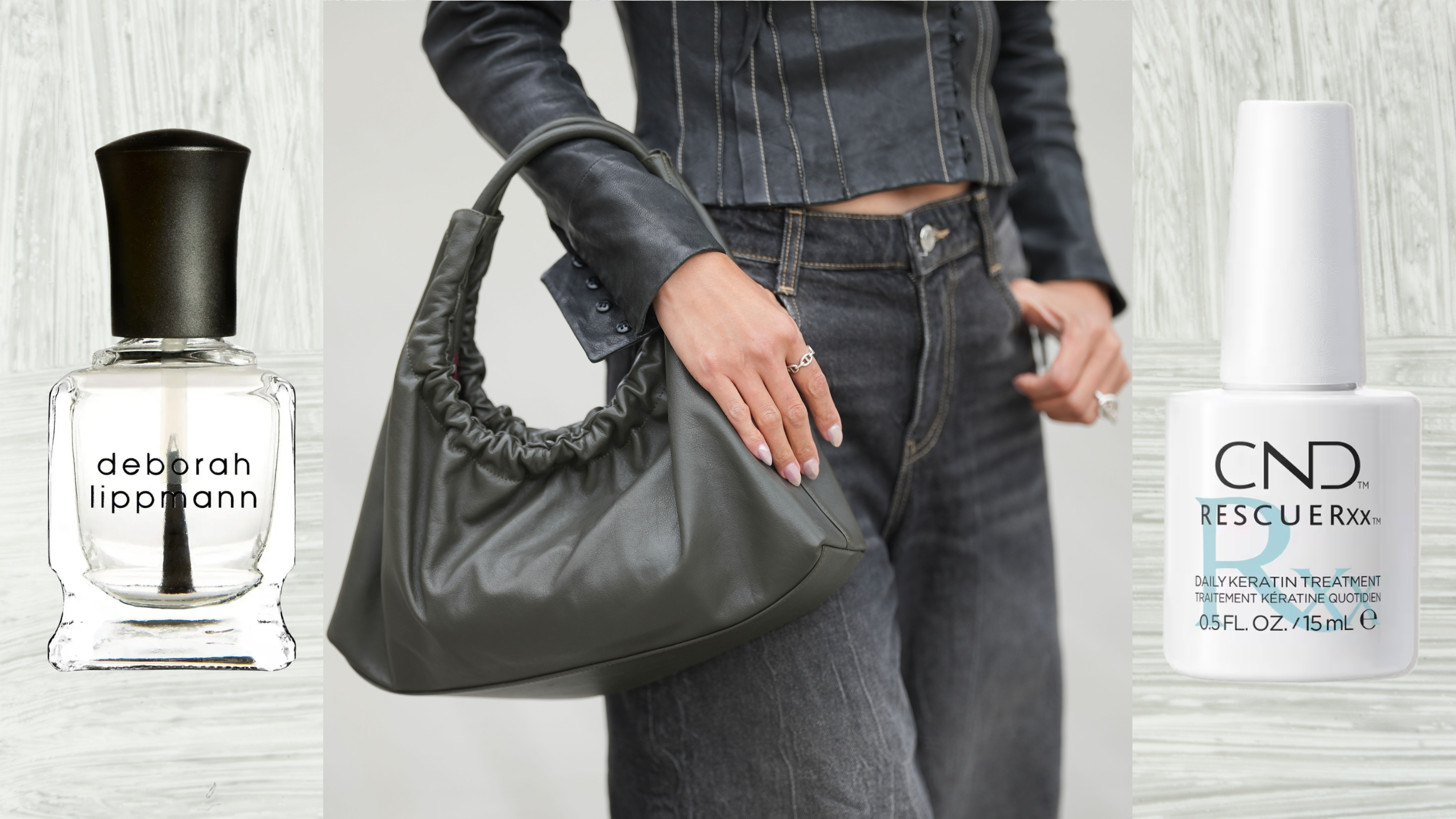 A woman in a black jean jacket and pants holding a black purse while resting her manicured hand on it. She is flanked by two bottles of nail treatments.