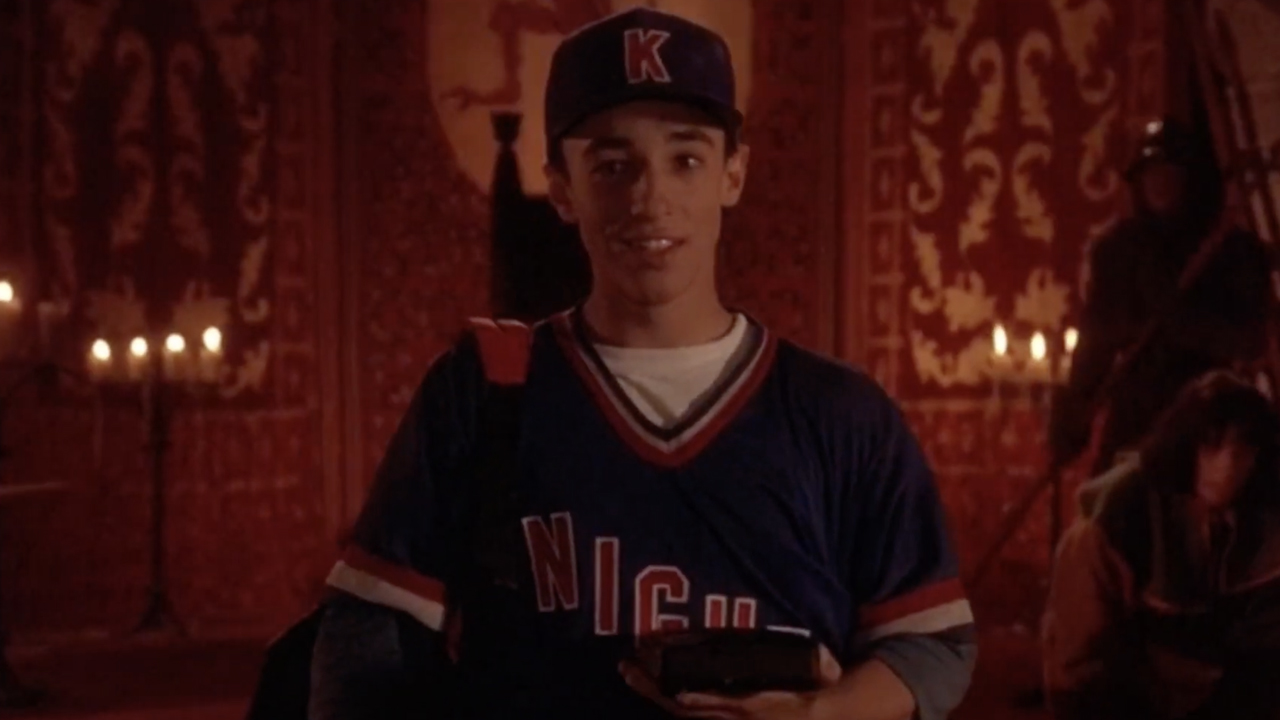 Thomas Ian Nicholas starring in A Kid in King Arthur's Court, standing in a baseball jersey in front of candles.