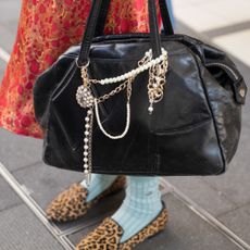 woman carrying a black duffel bag 