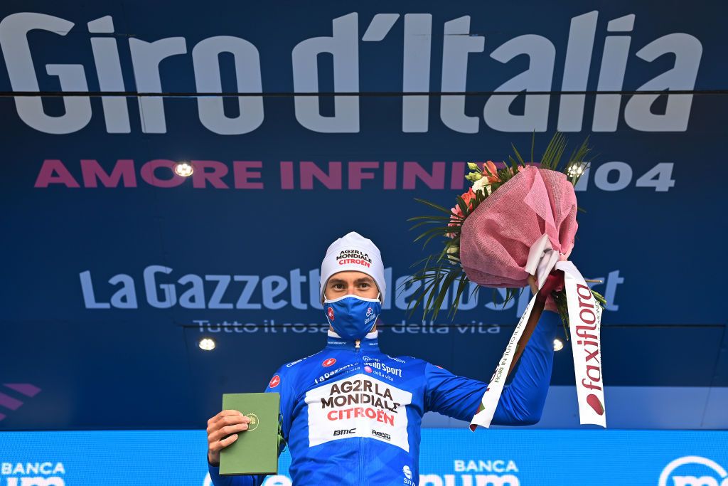 VALLE SPLUGA ALPE MOTTA ITALY MAY 29 Geoffrey Bouchard of France and AG2R Citren Team blue mountain jersey celebrates at podium during the 104th Giro dItalia 2021 Stage 20 a 164km stage from Verbania to Valle Spluga Alpe Motta 1727m Mask Covid safety measures The peloton passing through flowery landscape UCIworldtour girodiitalia Giro on May 29 2021 in Valle Spluga Alpe Motta Italy Photo by Stuart FranklinGetty Images