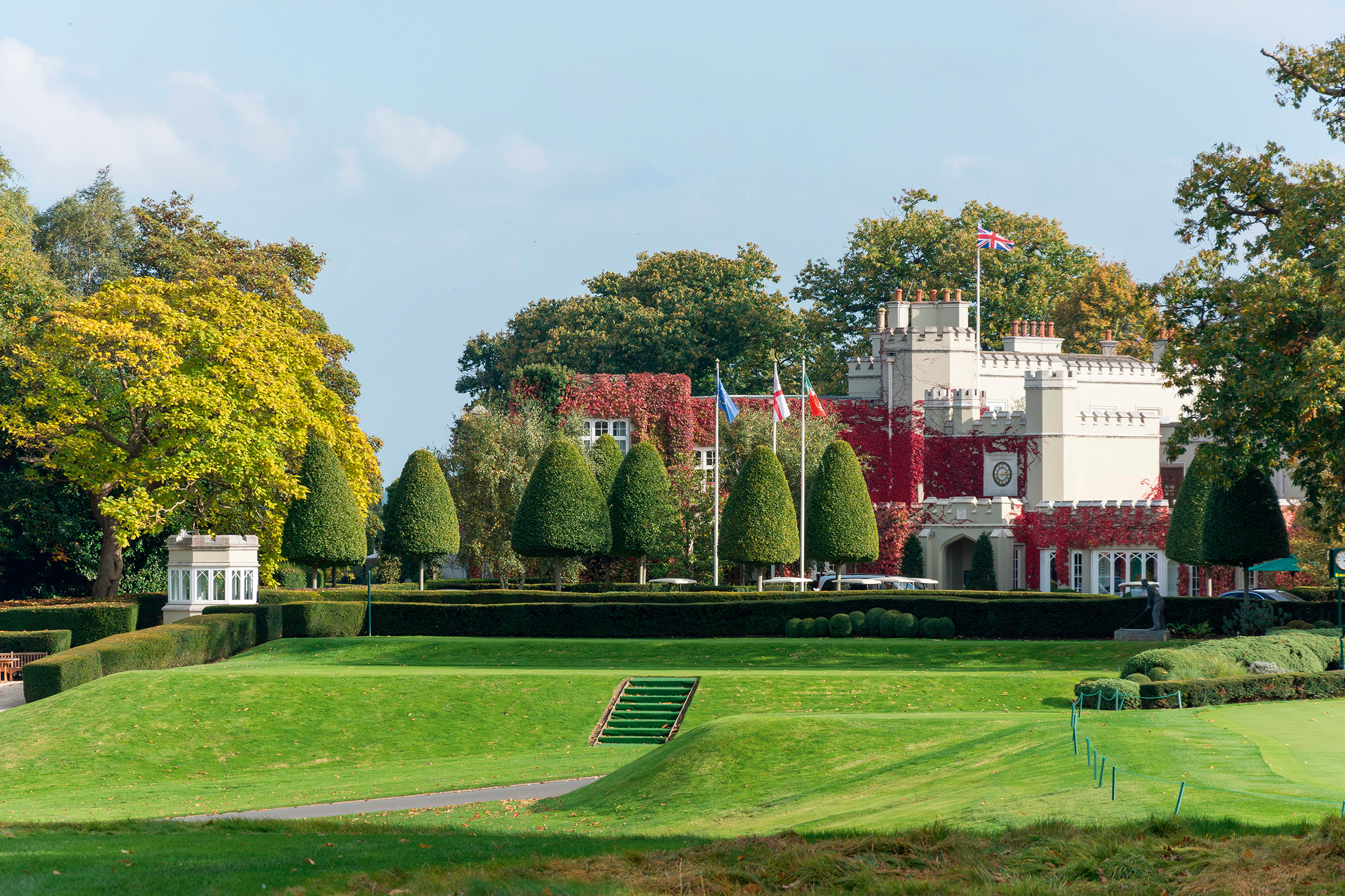 The Wentworth estate, the creation of Walter George Tarrant, is centred around the world-famous championship golf course — or rather, the three golf courses, as it is these days. This view shows the famous clubhouse and the first tee on the West Course, the toughest of the three, and a venue for countless professional tournaments down the years.