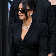 Kim Kardashian leaving a french court wearing sunglasses and repossi diamonds