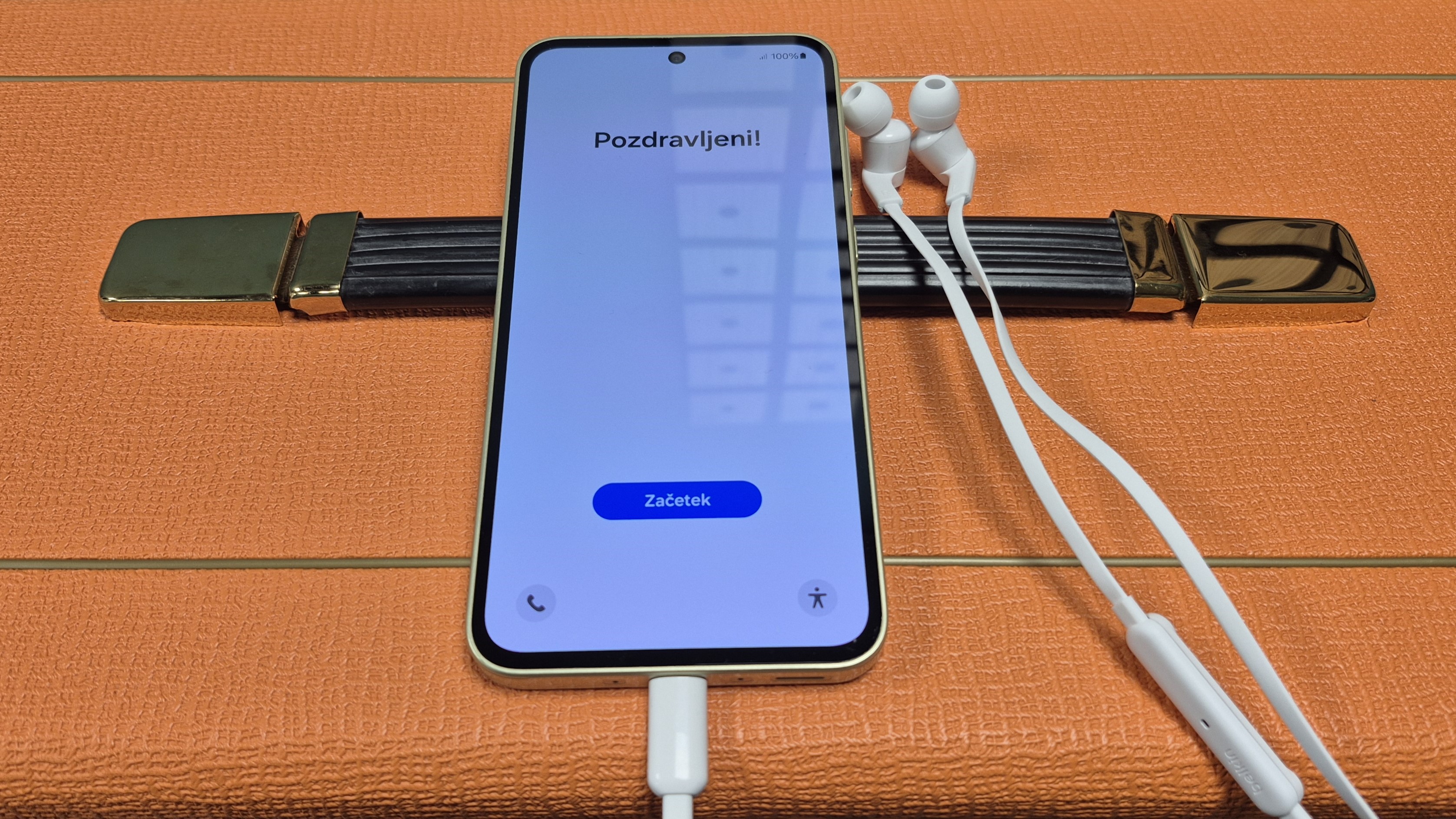 Belkin SoundForm Wired Earbuds with USB-C Connector plugged into Samsung Galaxy A35, which is sat on top of an orange amp