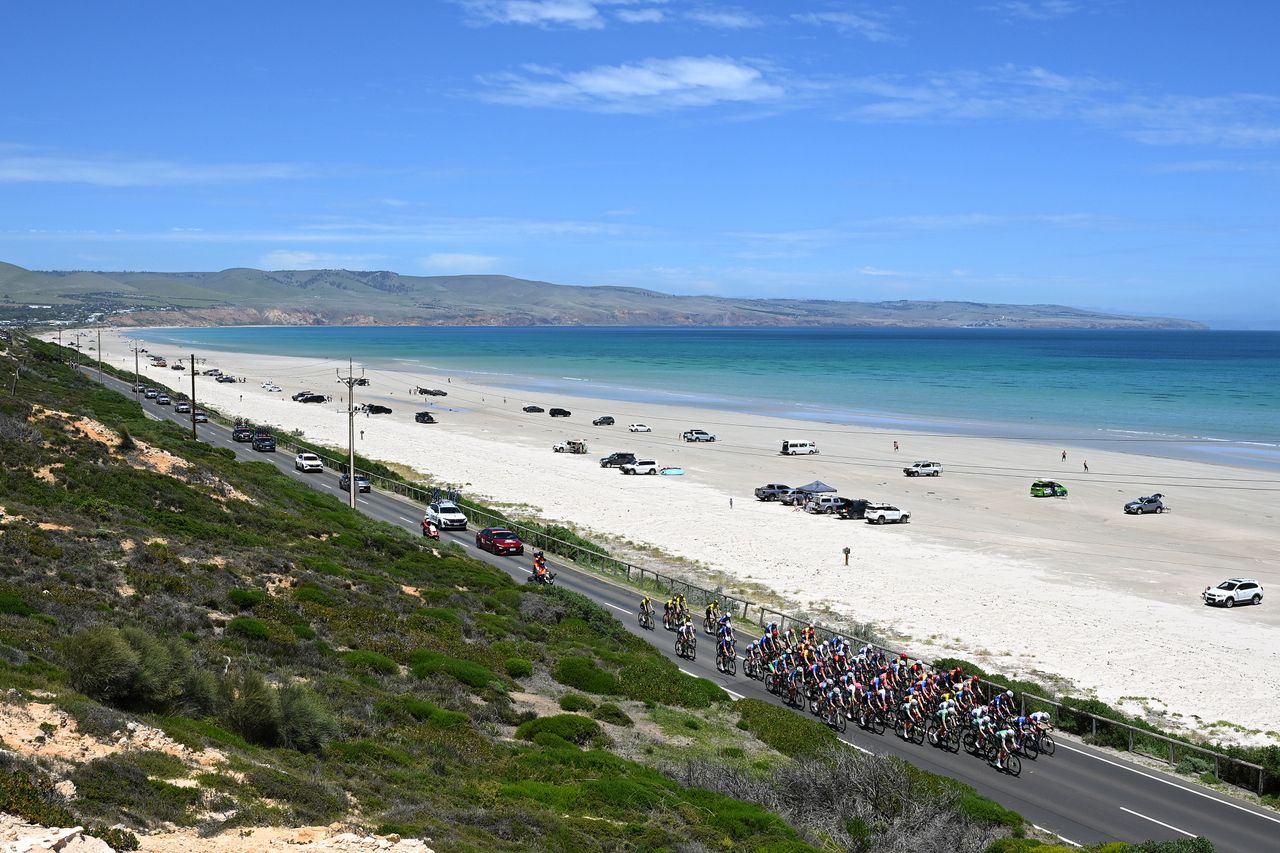 The women&#039;s peloton passes a beach at the 2024 Tour Down Under