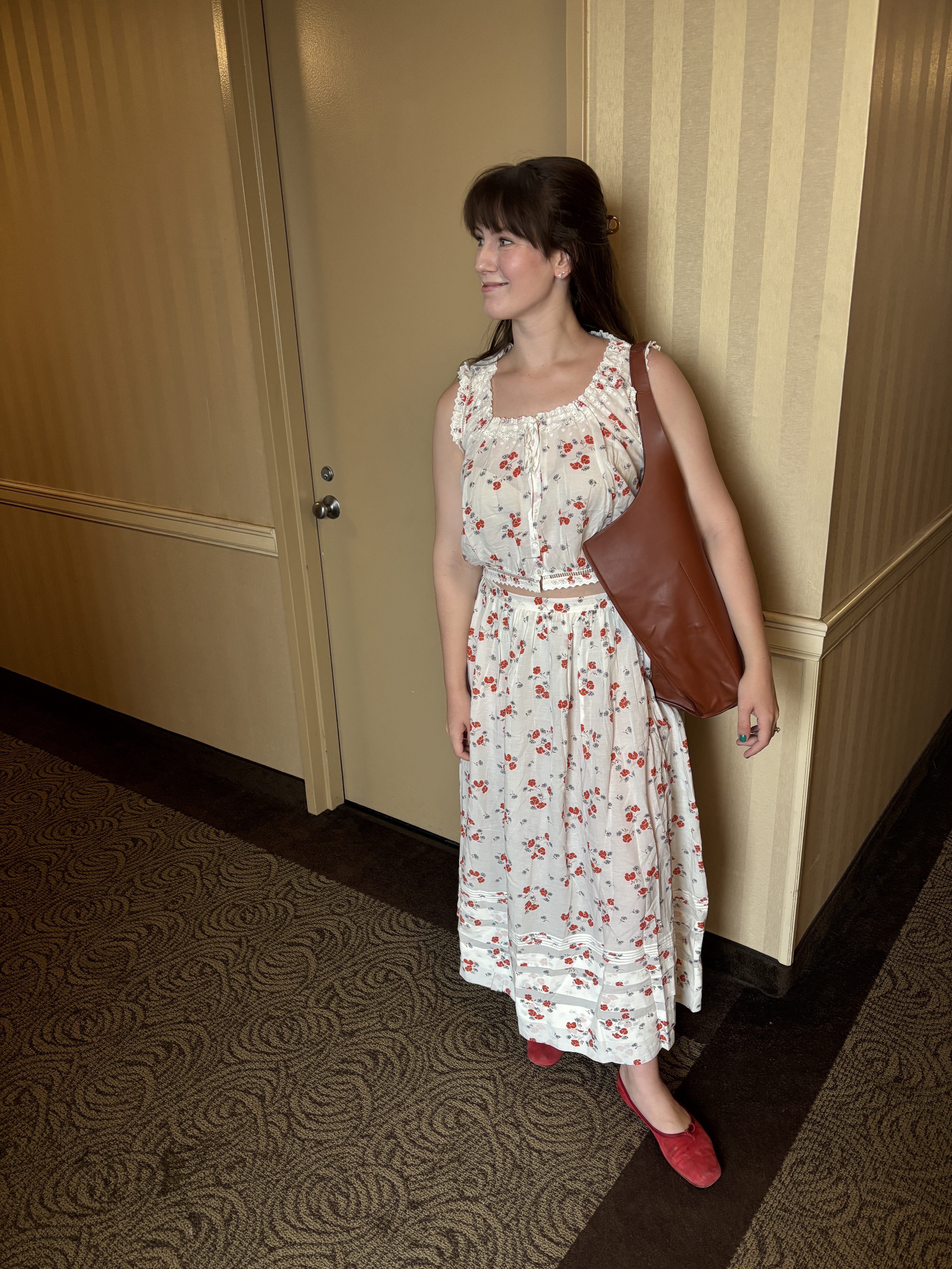 Halie LeSavage stands in her hotel building wearing a Dôen matching set owned by Taylor Swift