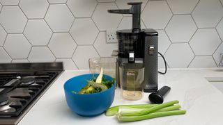 Nama Vitality 5800 on a kitchen countertop with green fruit and vegetables