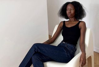 Sylvie Mus wearing a black tank top and jeans