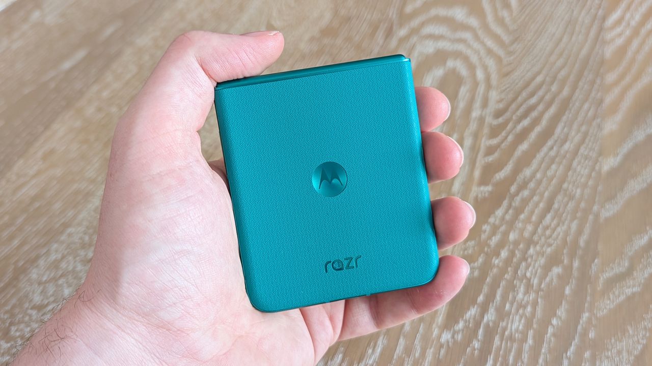 Motorola Razr 2026 in blue, being held in the hand