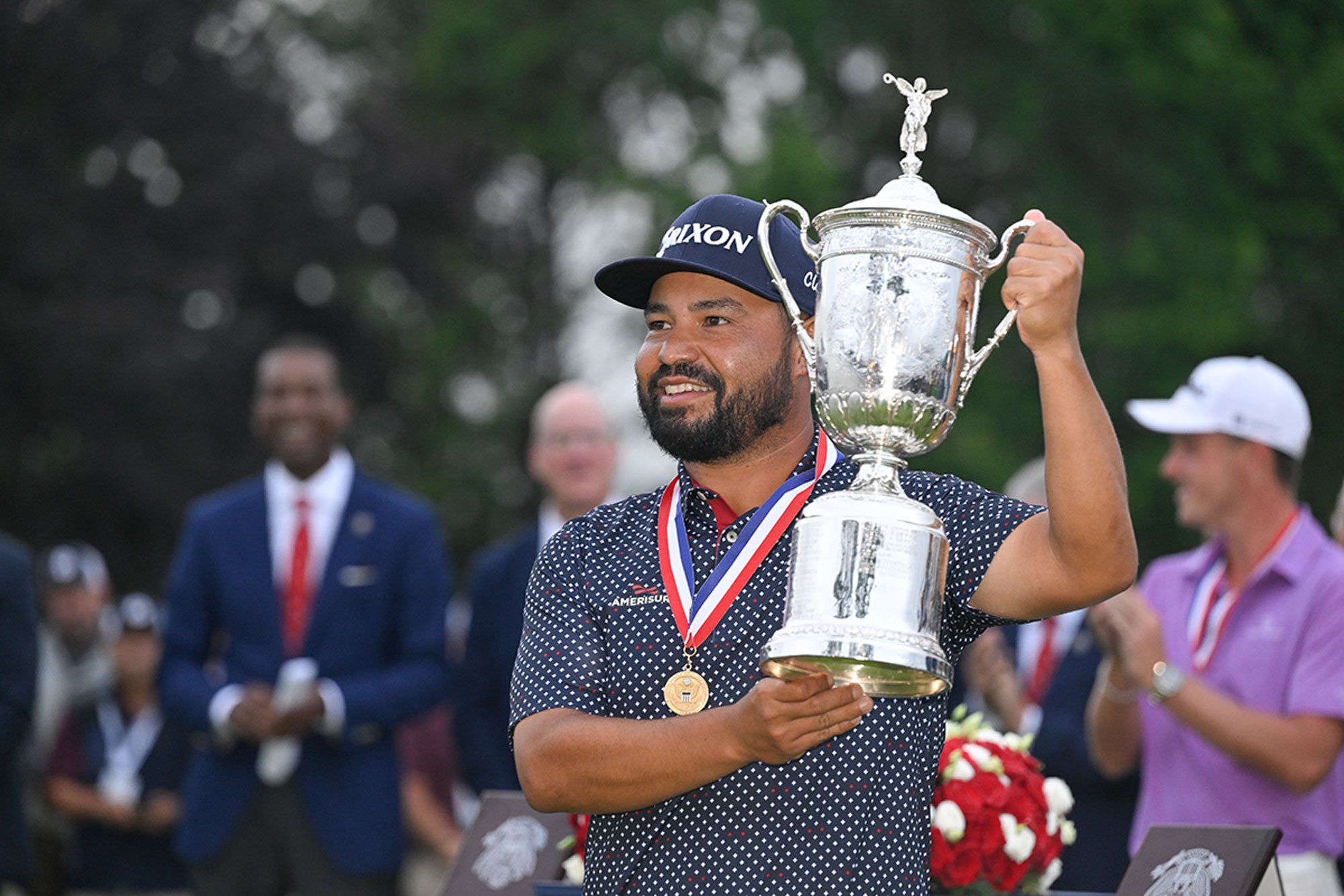 JJ Spaun holding the US Open trophy, wearing the winner's medal, after securing a first Major win at Oakmont Country Club