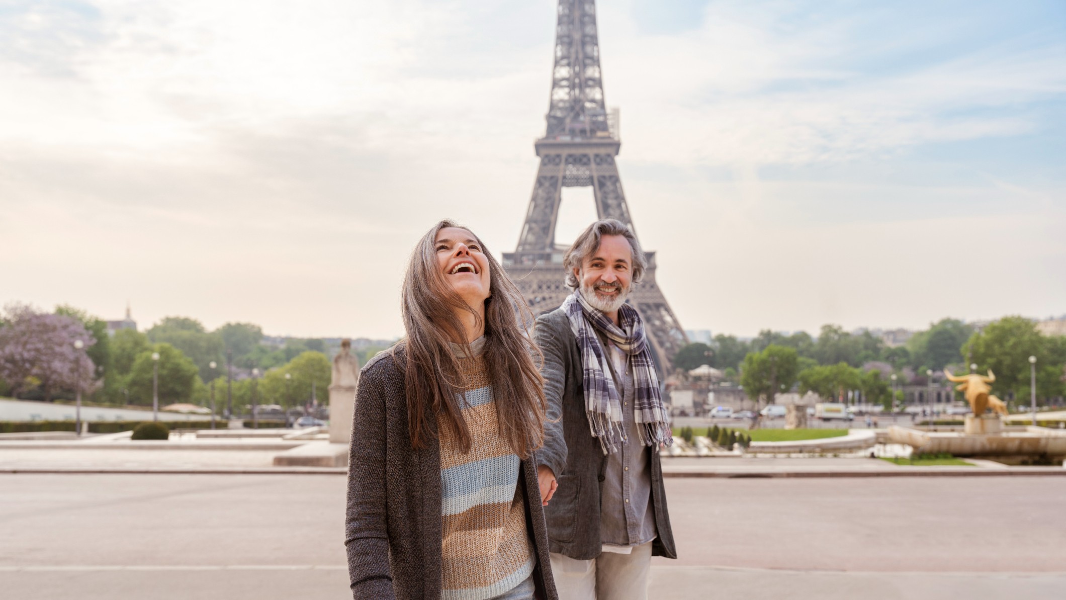 Happy mature couple in front of Eiffel Tower, Paris, France.