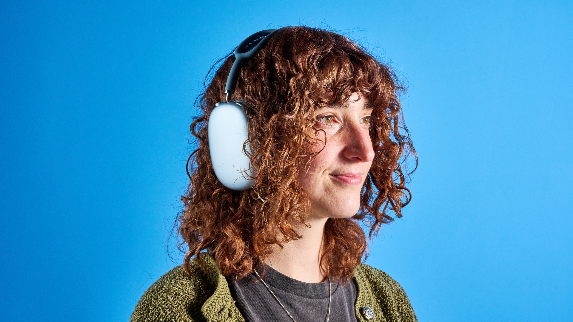 the airpods max (2024 edition) in blue photographed against the blue tom's guide background