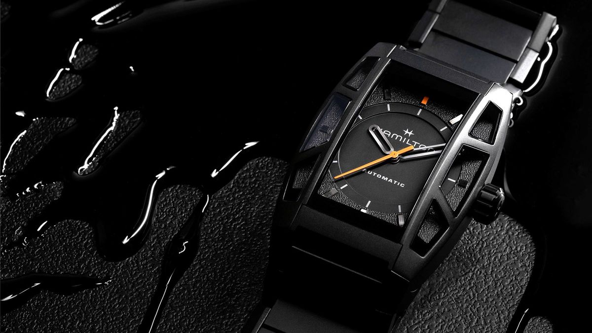 Hamilton Death Stranding 2 watch, a black titanium watch with orange seconds hand on a black slick background. 