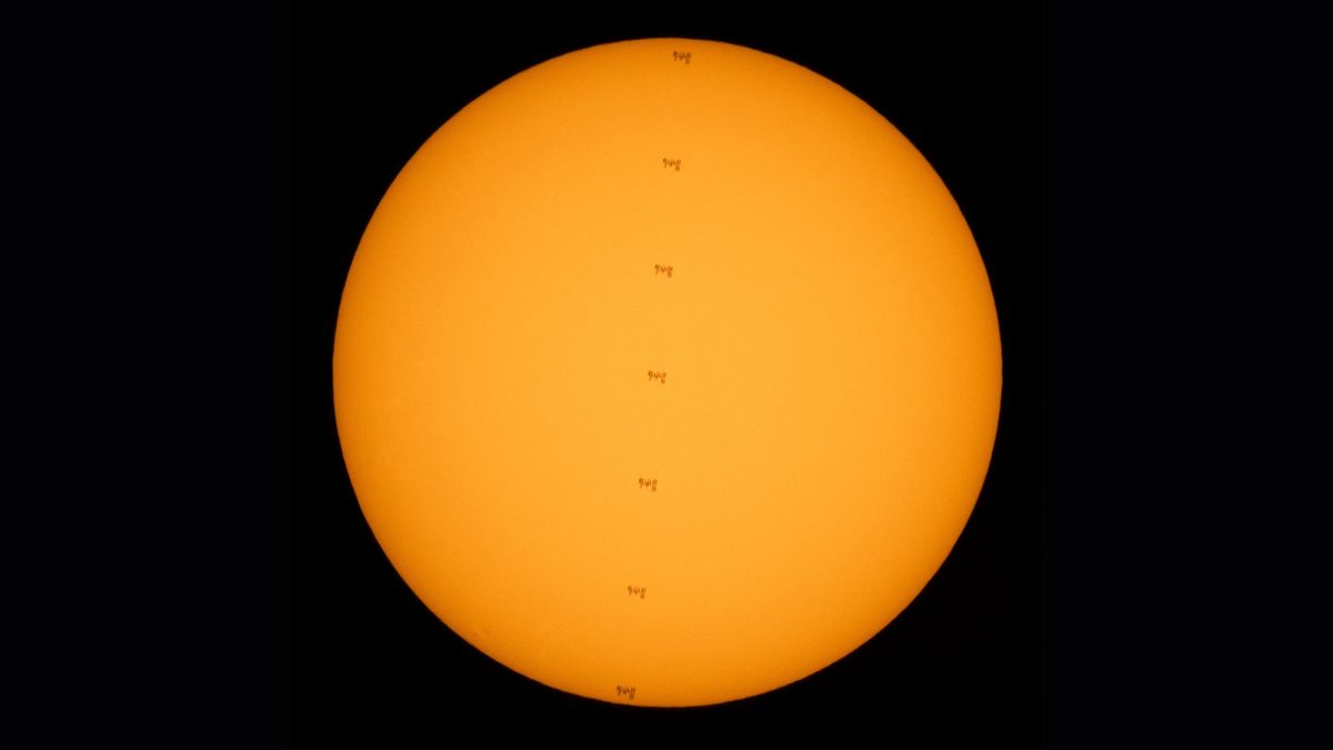 NASA photographer captured this stunning series of photos of the International Space Station crossing the face of the sun while two astronauts worked outside the outpost on July 25, 2021.