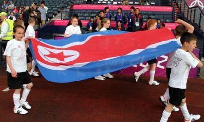 Kids carry the national flag of North Korea before the match between Colombia and North Korea at the London Games on July 25: Earlier during introductions a video promoting the North Korean t