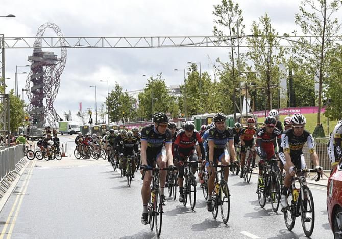The peloton roll out of the Olympic Park in Stratford