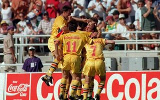 ROMANIAN PLAYERS SWAMP GHEORGHE HAGI AFTER HE SCORES THE SECOND GOAL DURING THE COLOMBIA VERSUS ROMANIA MATCH AT THE ROSE BOWL STADIUM IN PASADENA, CALIFORNIA