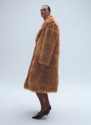 Model in fax fur coat and tights