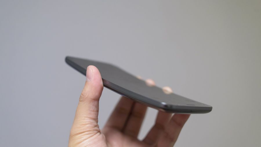 A hand holding the LG G Flex phone