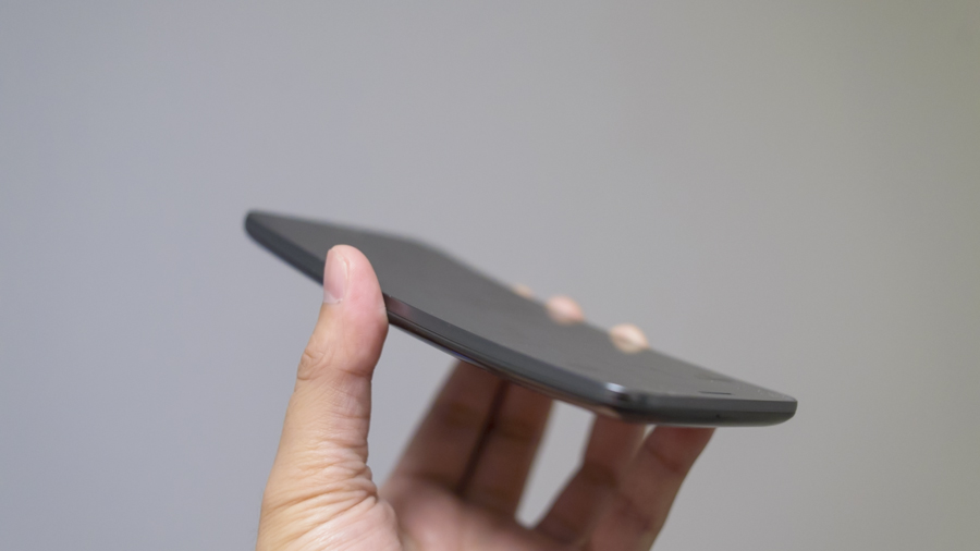 A hand holding the LG G Flex phone