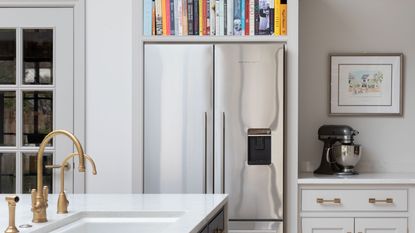 stainless steel refrigerator in kitchen with bookshelf