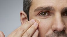 A man rubbing eye cream under his eye. The best men's eye cream