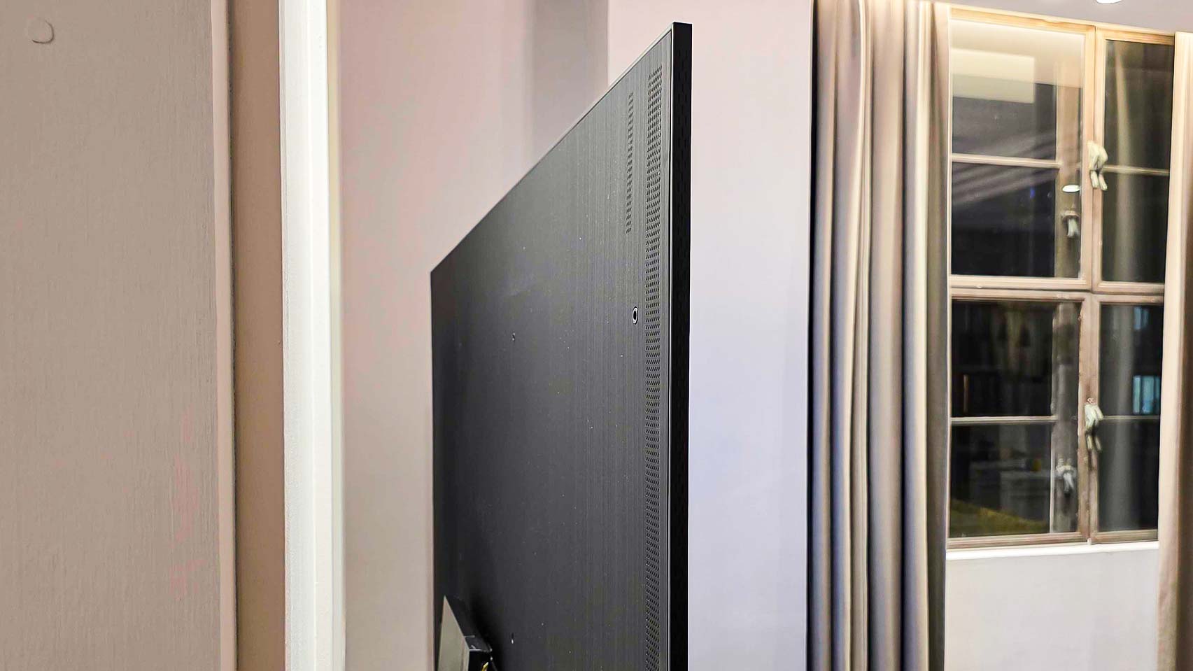 A rear right-hand-side view of the Samsung QN990F TV.