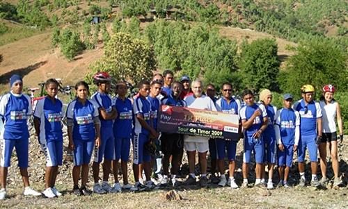 East Timor President Dr Jose Ramos-Horta and the nation's cycling team display the US$15,000 winner's check.