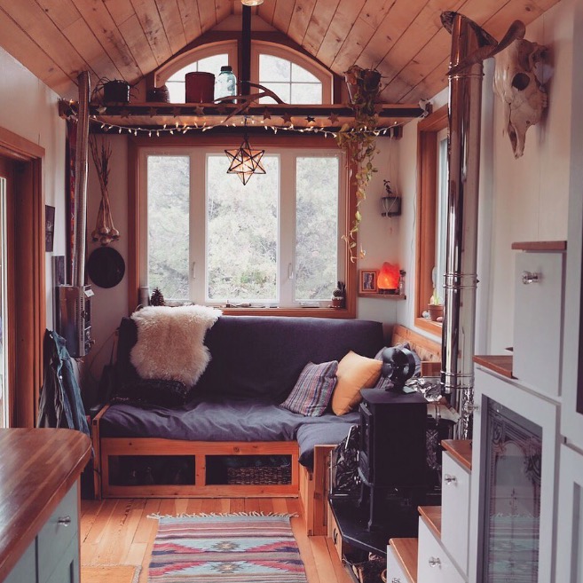 Cozy tiny home with built in sofa and storage
