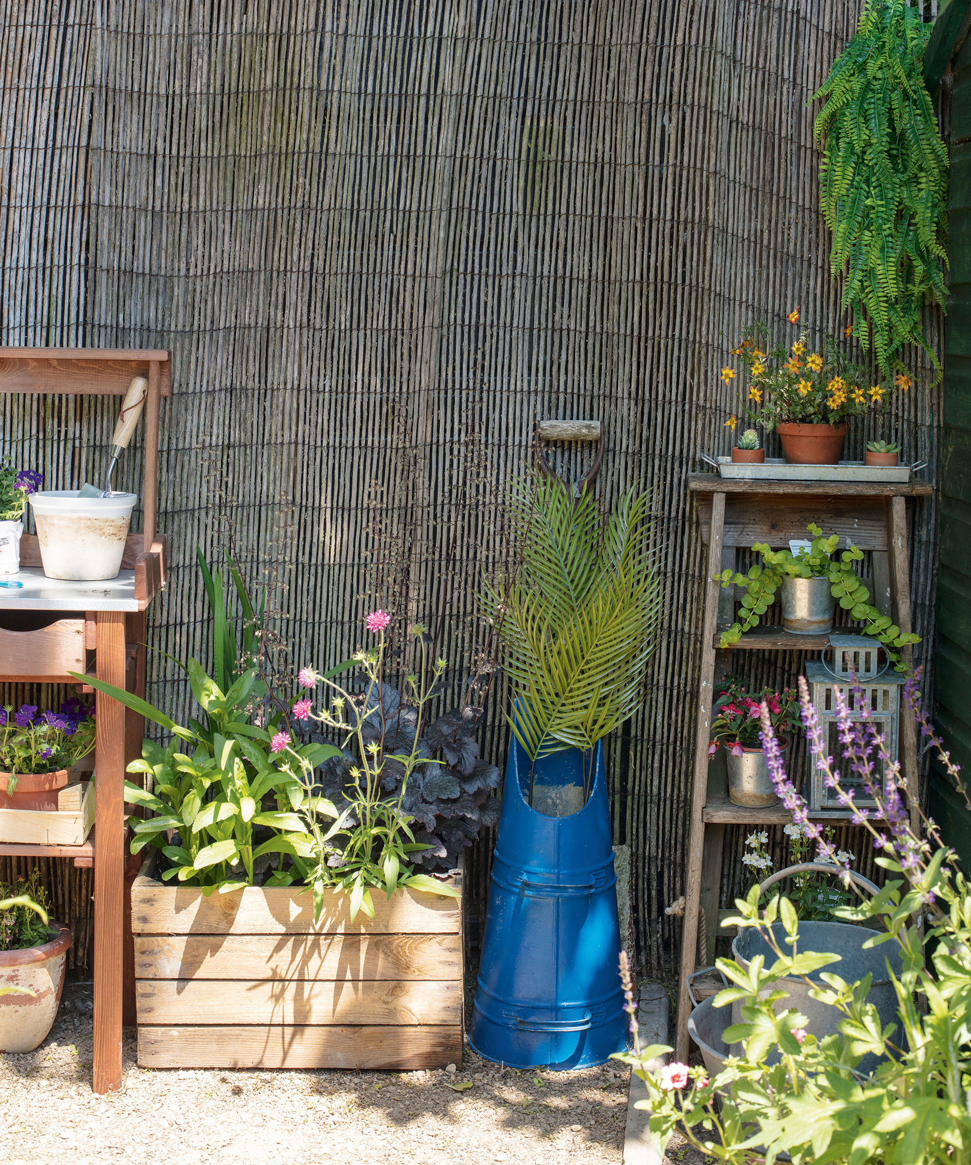 garden area with bamboo fence and flower pots