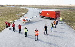 DronePrep and Royal Mail promotional image showing staff stood in front of a red van and plane