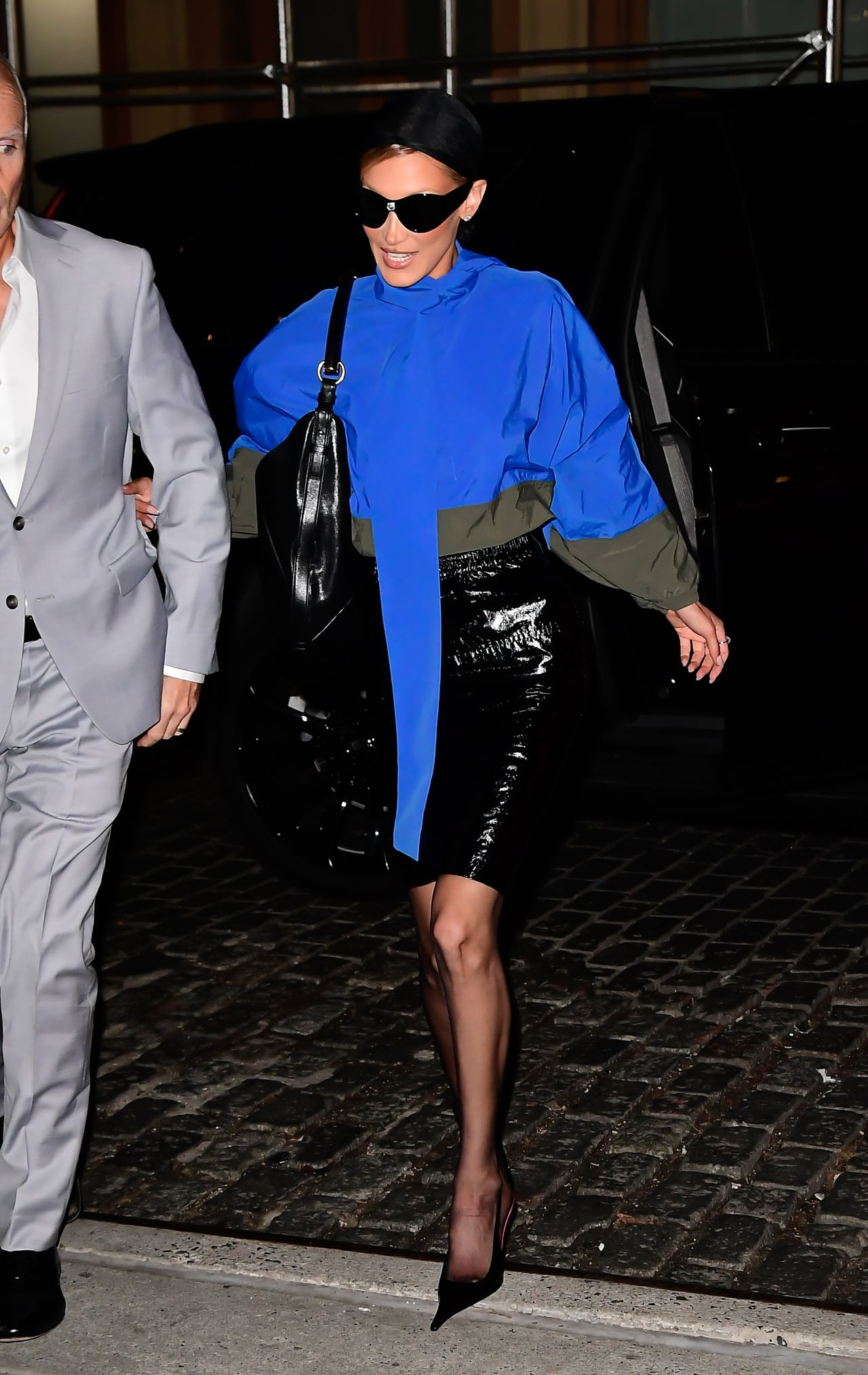 Bella Hadid is seen on January 14, 2026 in New York City wearing a cobalt blue blouse and black skirt.