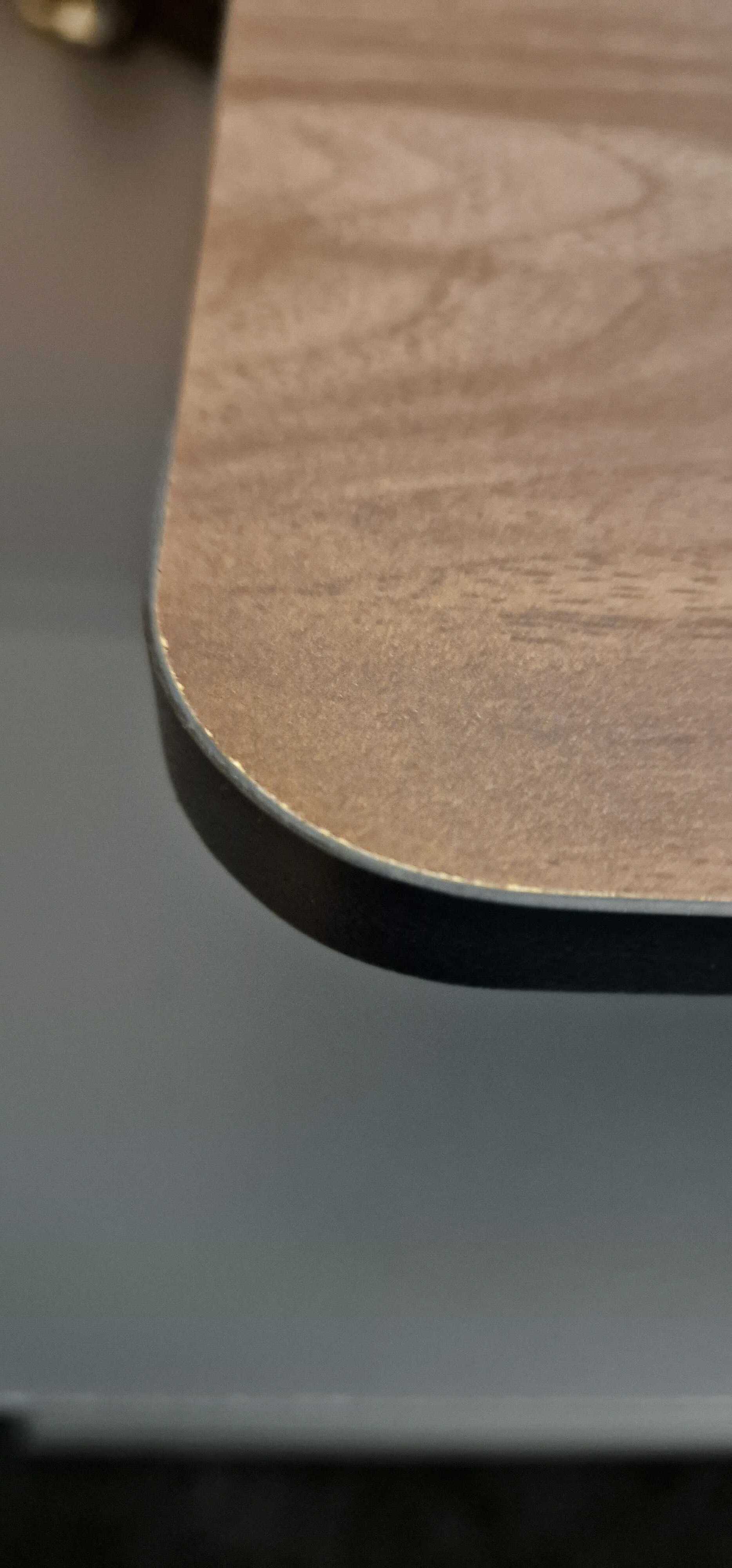 Close-up of the corner of the Fezibo monitor stand showing slight defects.