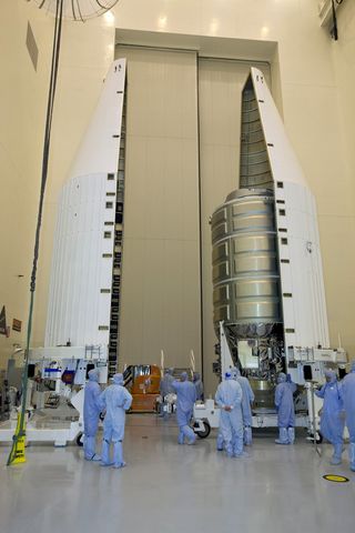 The Orbital ATK Cygnus spacecraft undergoes encapsulation in the Atlas V rocket fairing at NASA's Kennedy Space Center on Nov. 16, 2015.