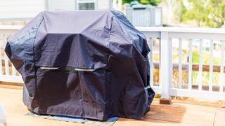 A grill stored under a cover