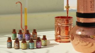 Six essential oil bottles next to a copper utensil