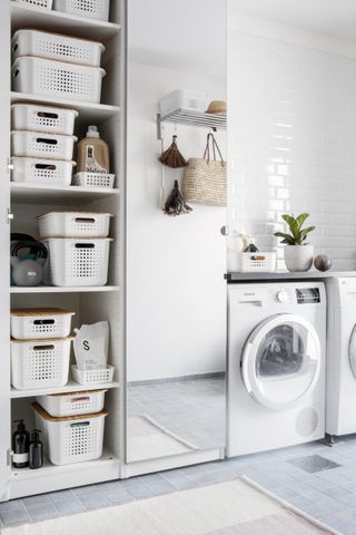 laundry appliances and storage in utility room