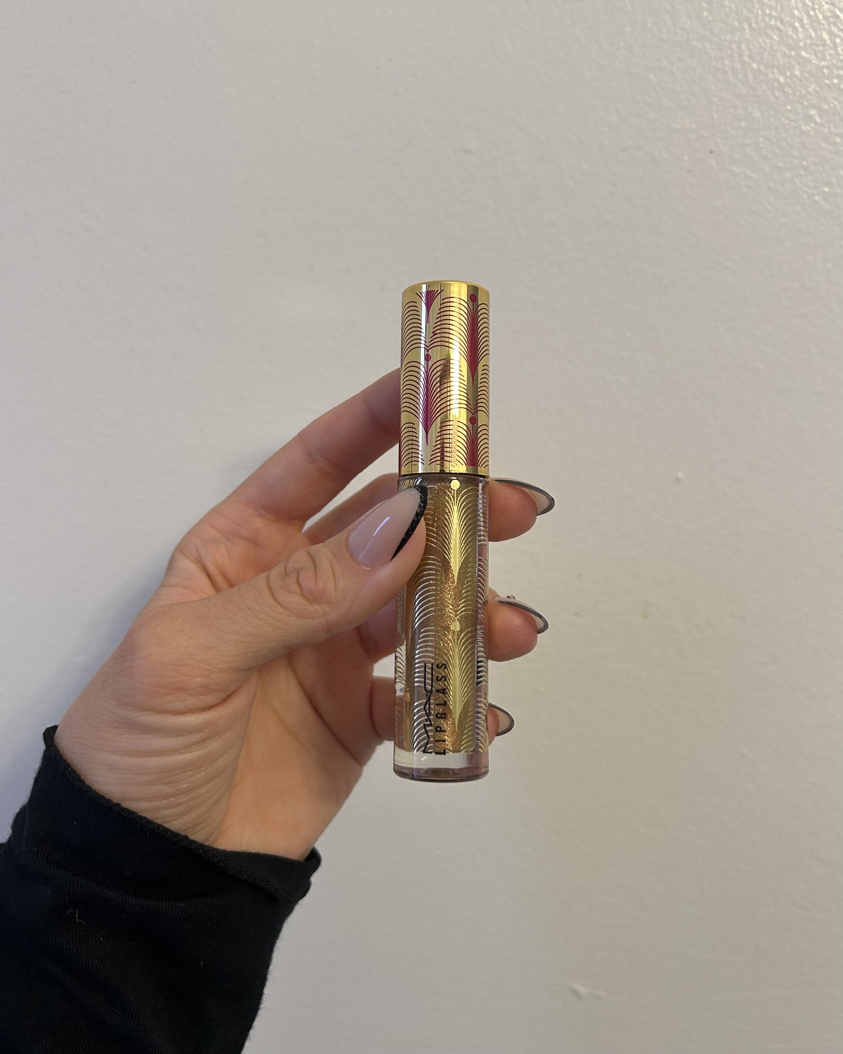 Alyssa Brascia holding the MAC Cosmetics Lipglass.