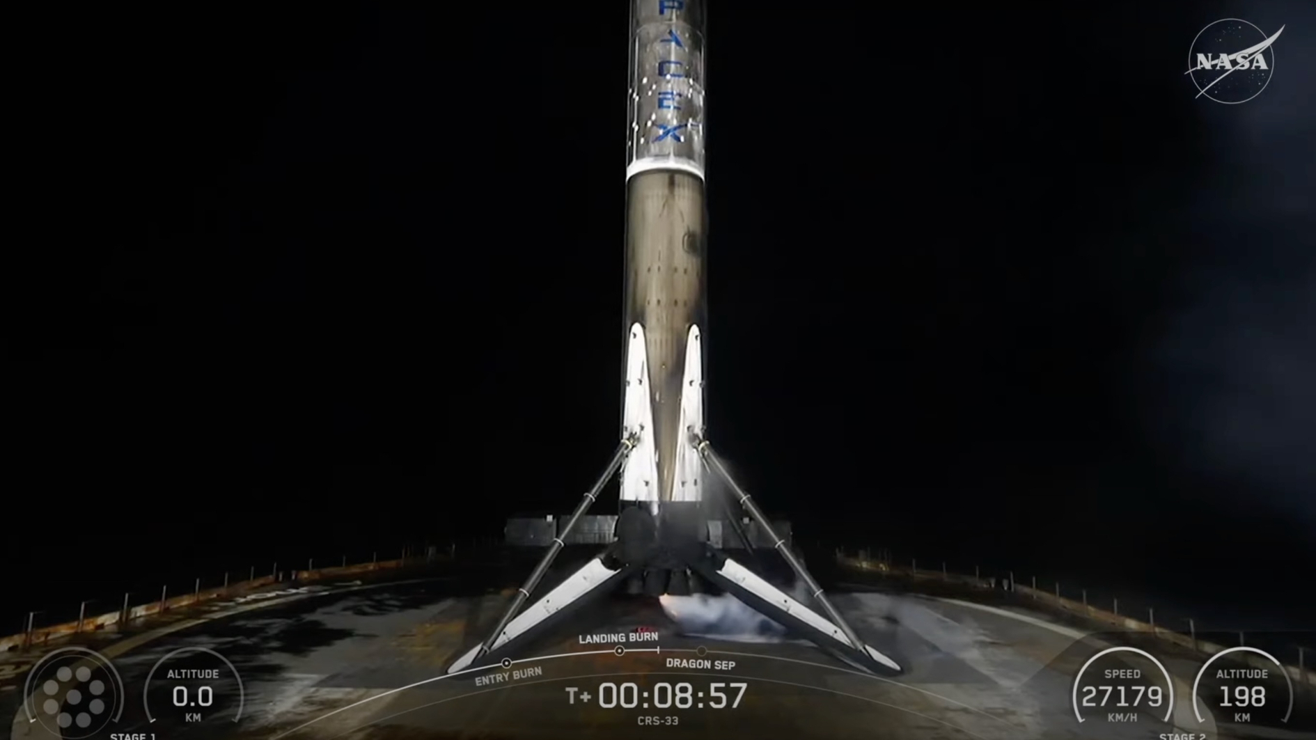 a black on white rocket rests on the deck of a ship at sea at night