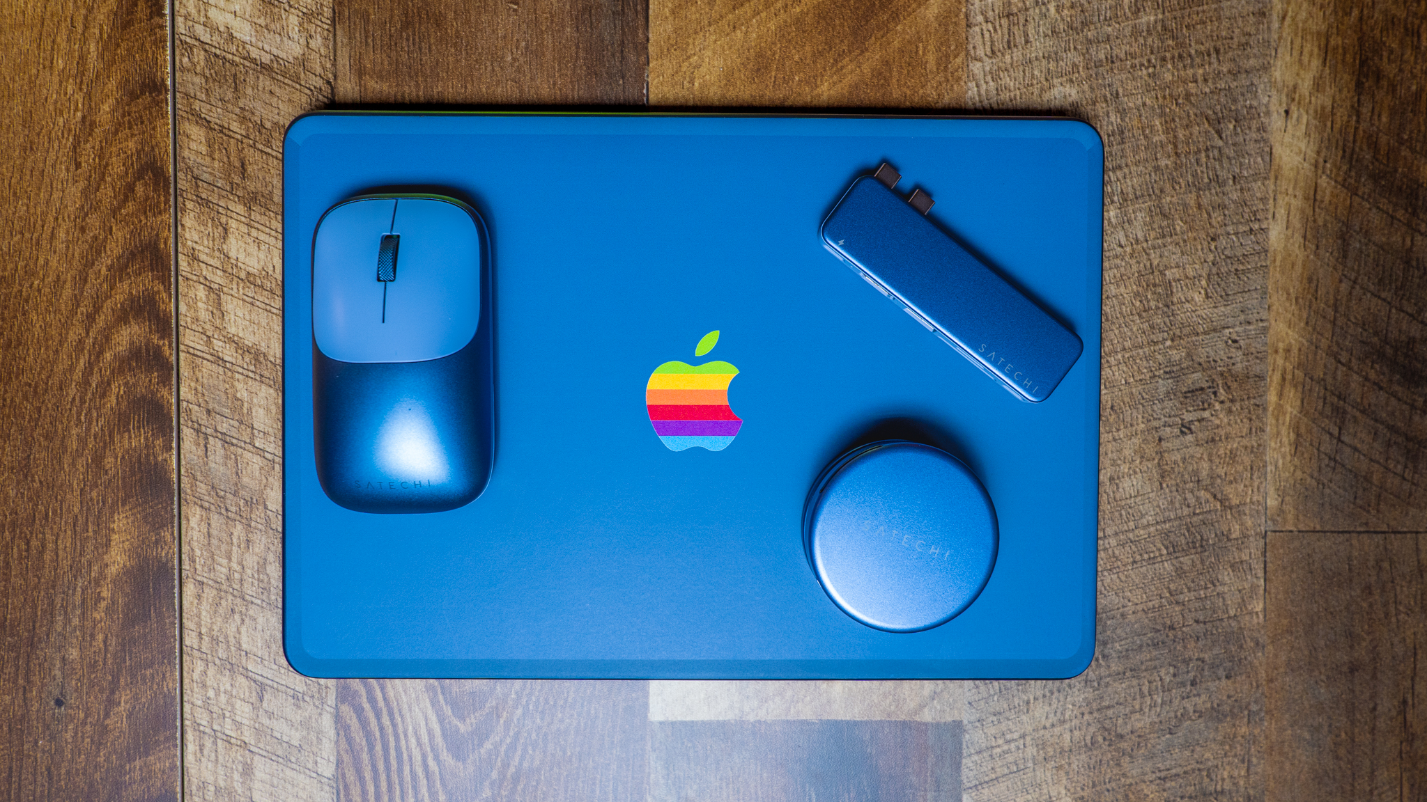 Satechi's color matching accessories on top of MacBook Neo lid