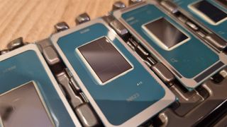 A row of Intel Core Ultra Series 3 chips on a wooden table