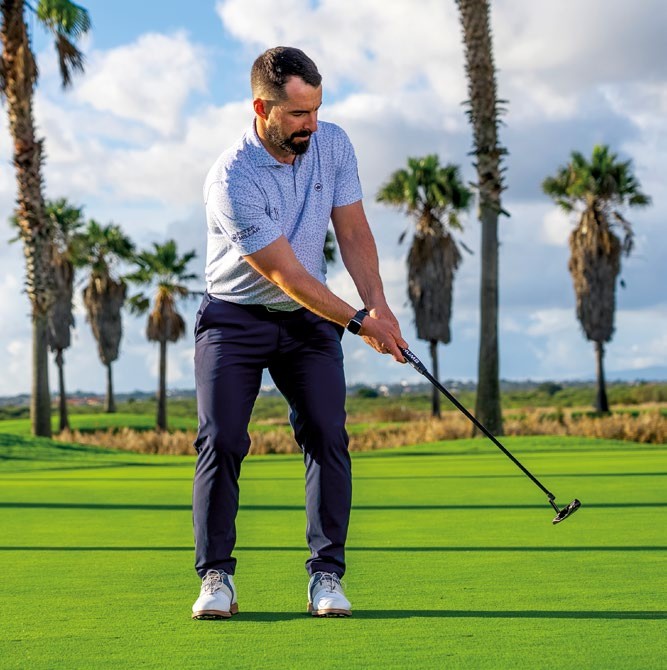James Jankowski past impact with the putter