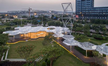 An aerial view of the building photographed from the sky with a view of the manicured lawn and trees surrounding the building