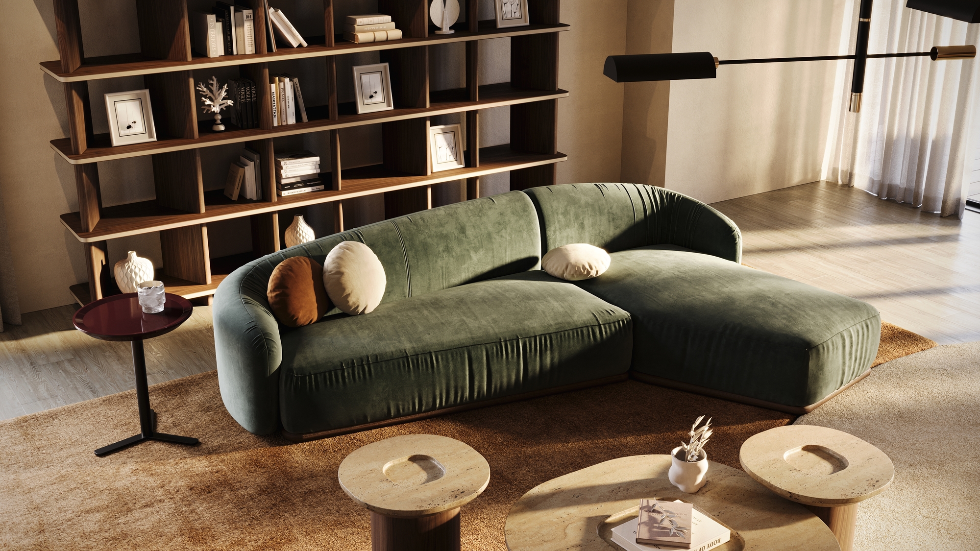 green curved sofa with freestanding bookshelf behind, side table next to the sofa, and nesting coffee table with three round tables of varying sizes