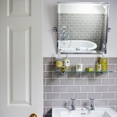 Bathroom mirror, sink white wall with grey tiles