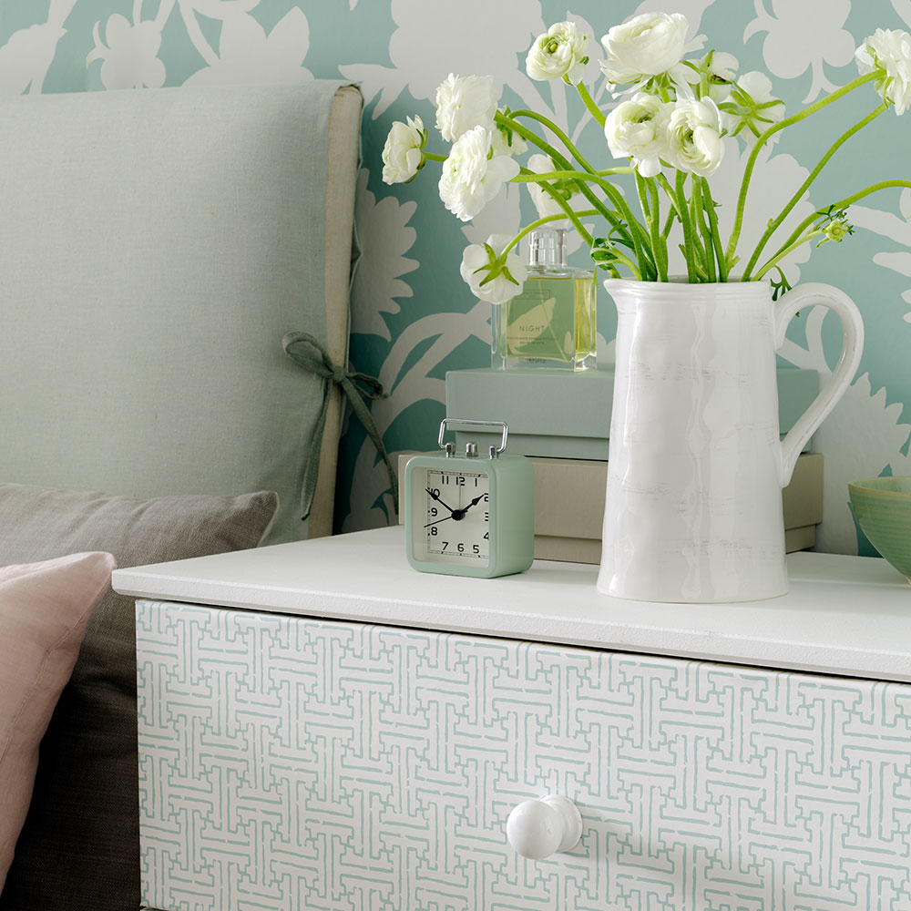 bedroom with white table and flower vase