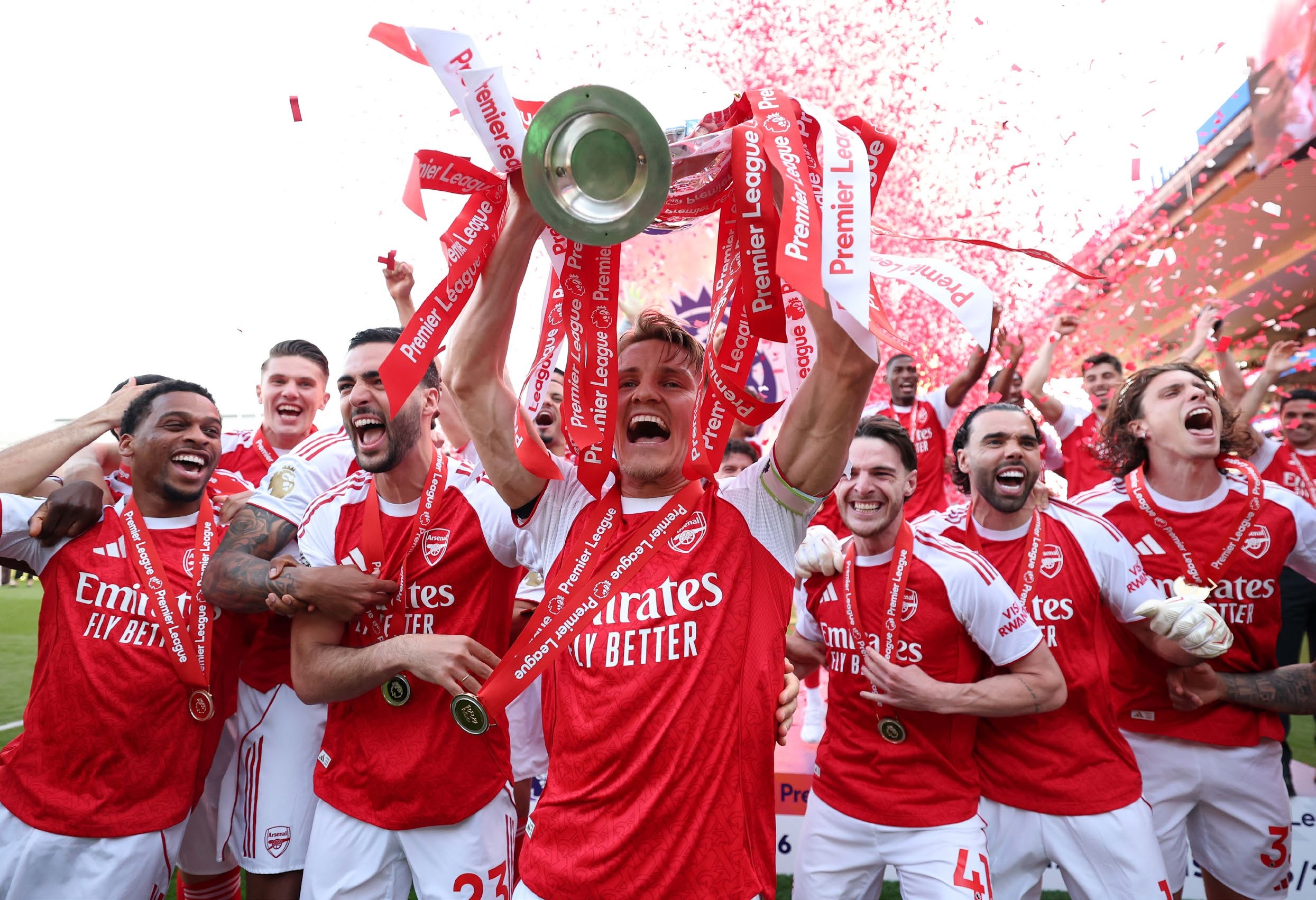 Martin Odegaard lifts the Premier League trophy as players of Arsenal celebrate. (Photo by Michael Regan/Getty Images For Premier League) FFT394.pl_arsenal.gettyimages_2278001101