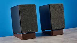 Onkyo GX-30ARC bookshelf speakers photographed on a blue background