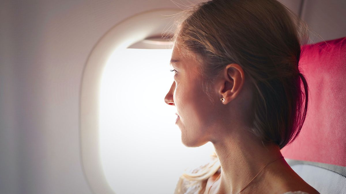 Woman looking out of airplane window