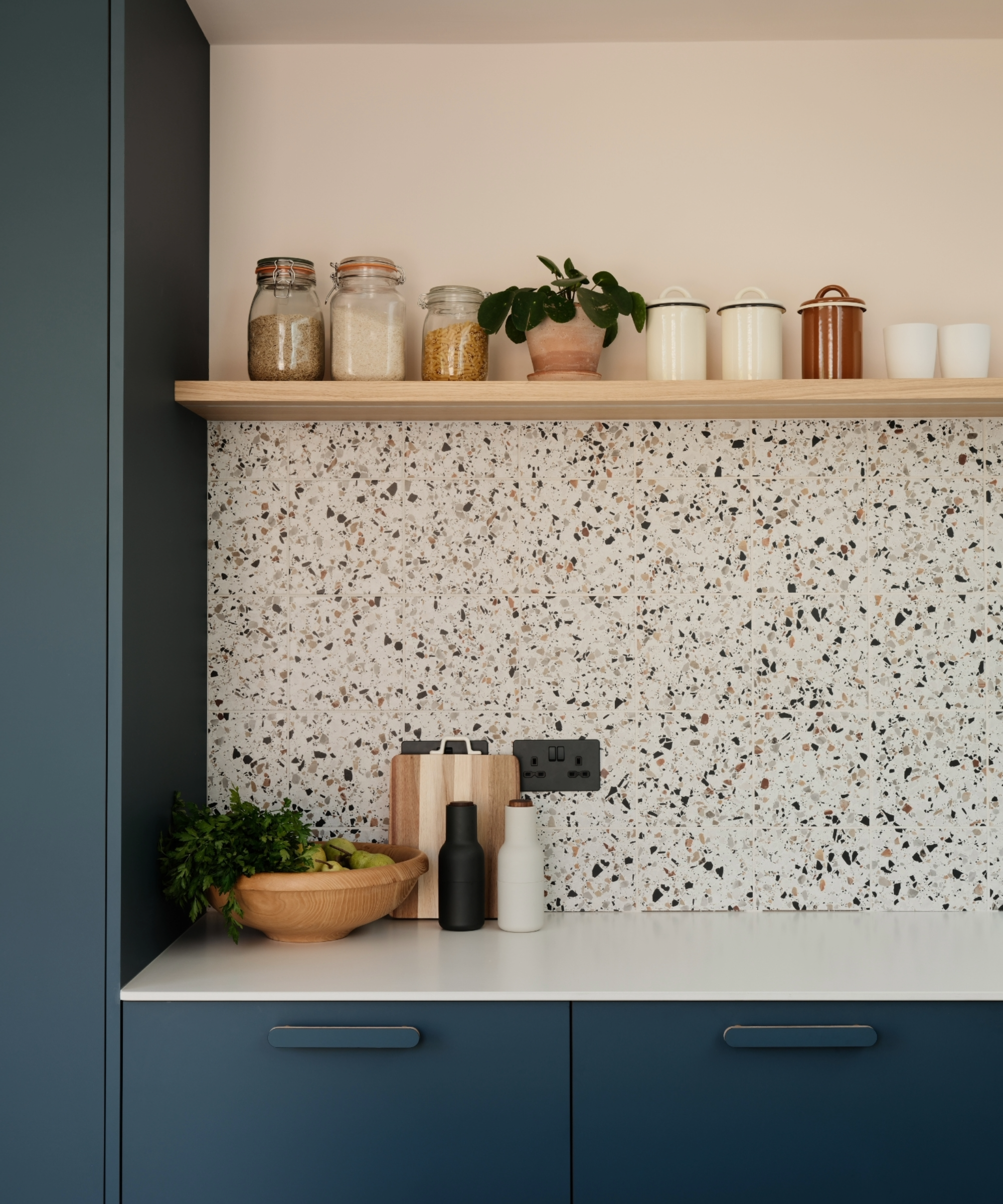 Kitchen with blue cabinets and terrazzo tiles